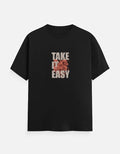 No Cap Co black 100% cotton t-shirt with "TAKE IT EASY" graphic print and floral detail.