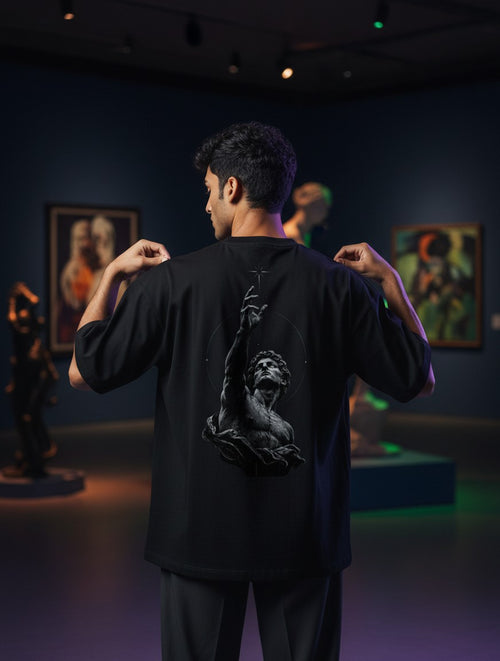 No Cap Co black oversized t-shirt with a graphic print of a statue reaching for a star.