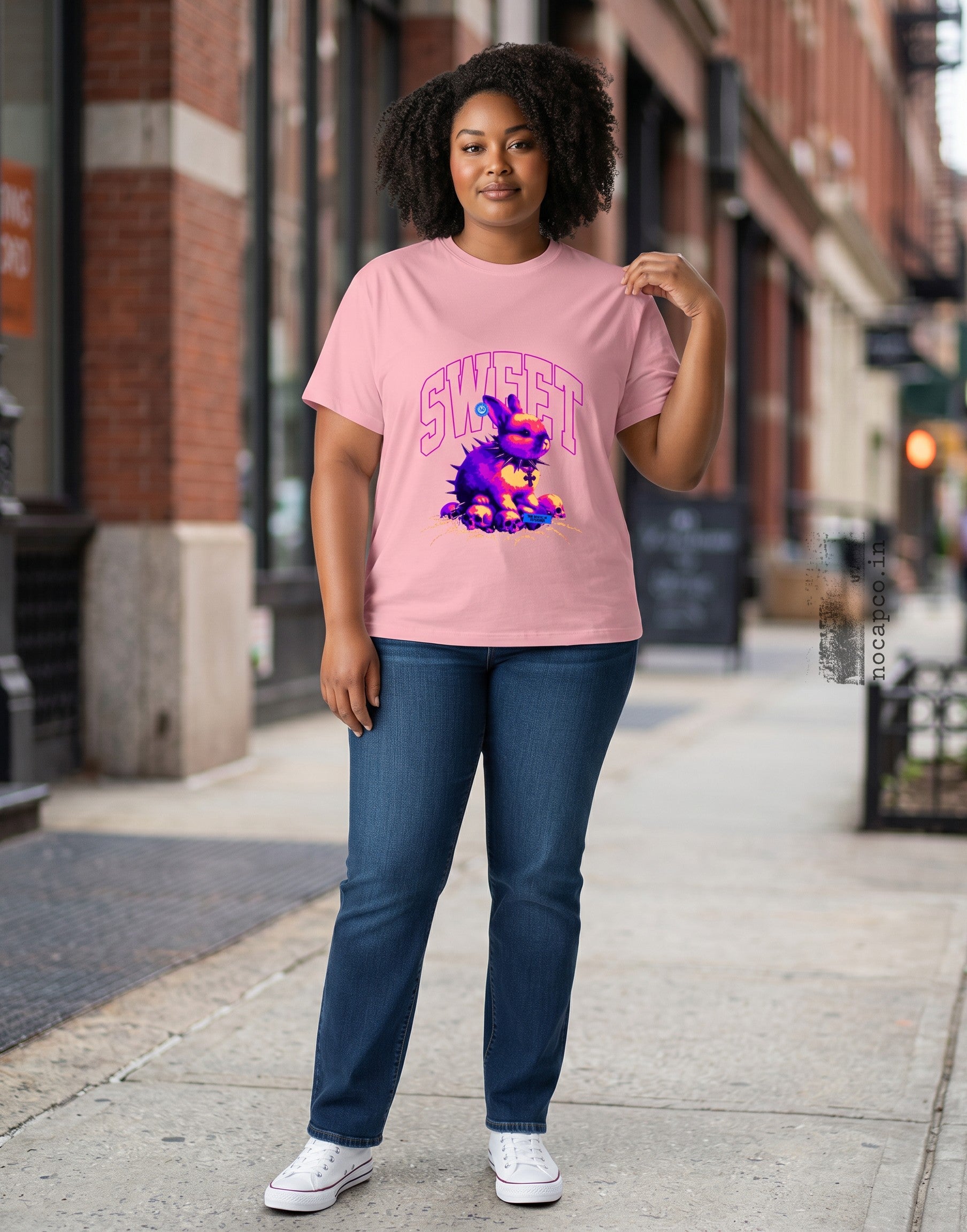 No Cap Co pink 100% cotton crew neck t-shirt with a graphic of a purple bunny wearing a spiked collar and surrounded by skulls.