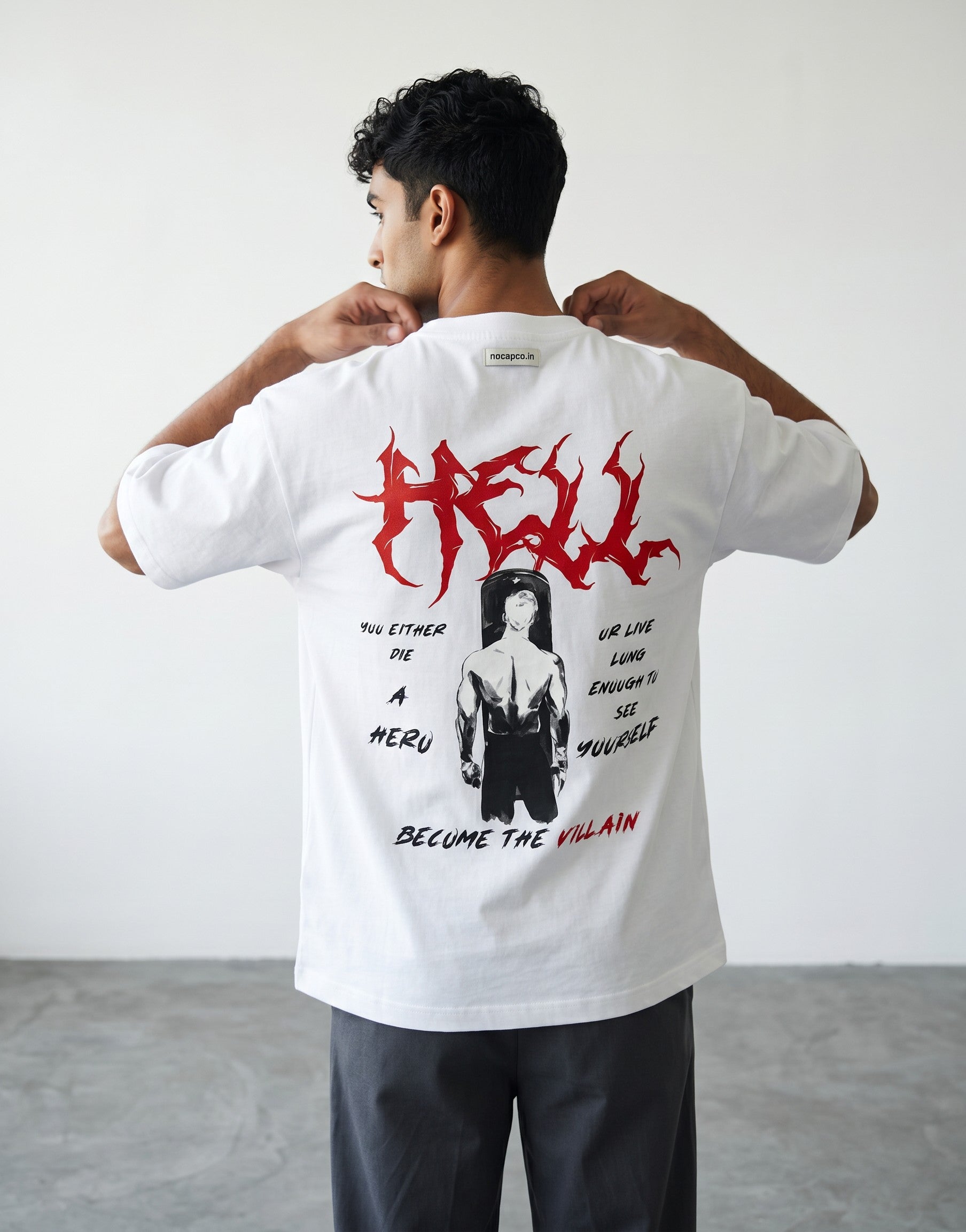 No Cap Co white oversized cotton t-shirt with red graphic text "HELL" and a graphic of a man with text.