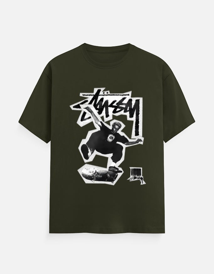 No Cap Co dark green 100% cotton crew neck t-shirt with a graphic print of a skateboarder mid-air.