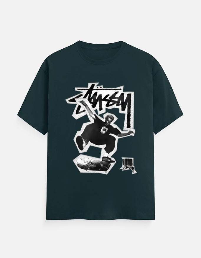 No Cap Co dark teal 100% cotton crew neck t-shirt with a graphic print of a skateboarder mid-air and brand logo.