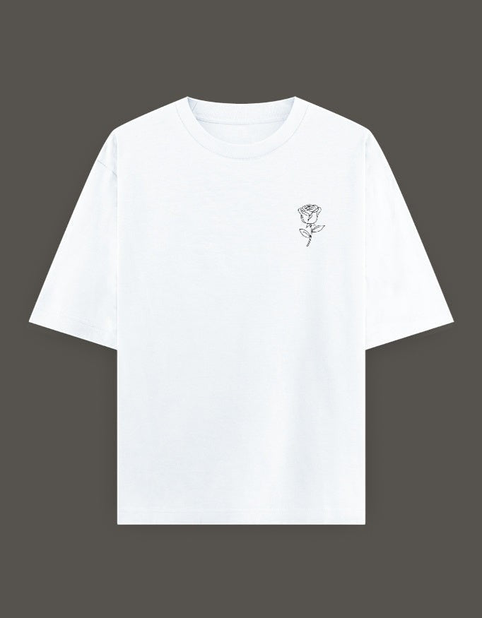 No Cap Co white oversized t-shirt with a small black rose graphic on the left chest. Made from 240 GSM cotton-polyester blend.
