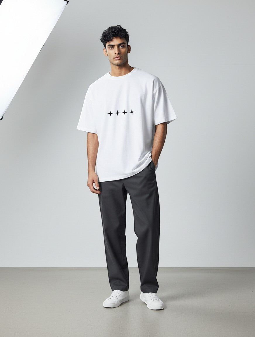 No Cap Co white oversized t-shirt with four black star graphic print on the chest. Premium 240 GSM cotton-polyester blend.
